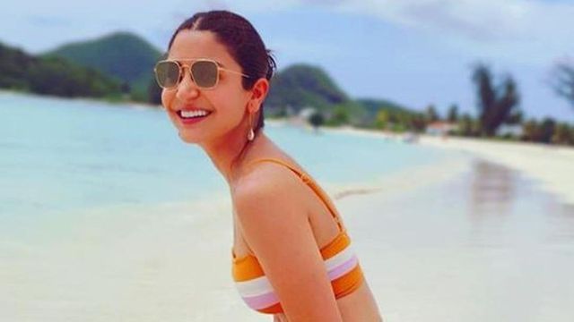 Anushka Sharma dons a tangerine bikini on the beach and we are as smitten as Virat Kohli