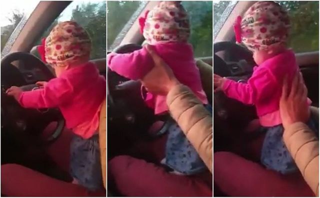 Un bărbat a fost filmat în timp ce conduce cu fetița lui în brațe