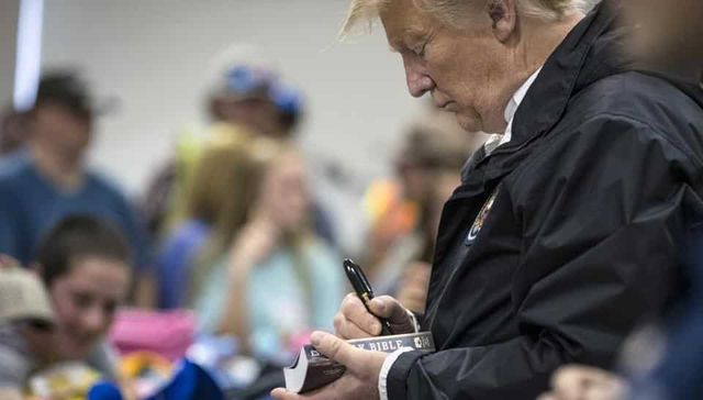 Donald Trump signs Bibles for tornado-hit people in Alabama