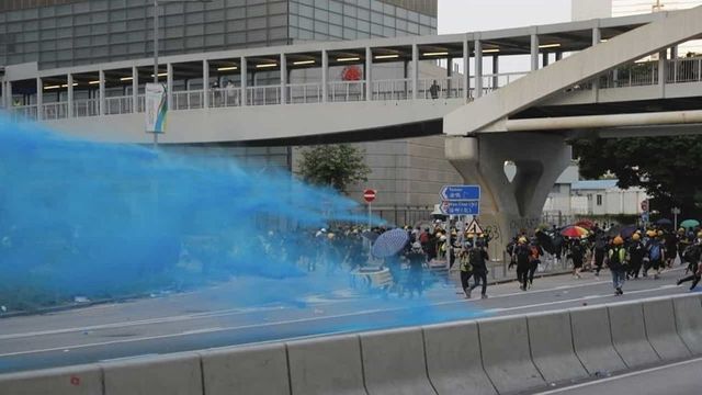 Hong Kong police fire tear gas, water cannon at protesters throwing petrol-bomb