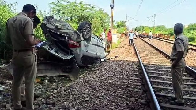 Car topples from flyover and lands on railway track injuring driver