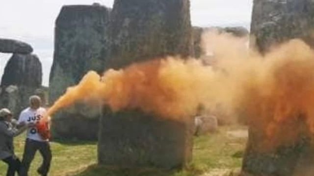 Two climate activists arrested after painting Stonehenge monument orange